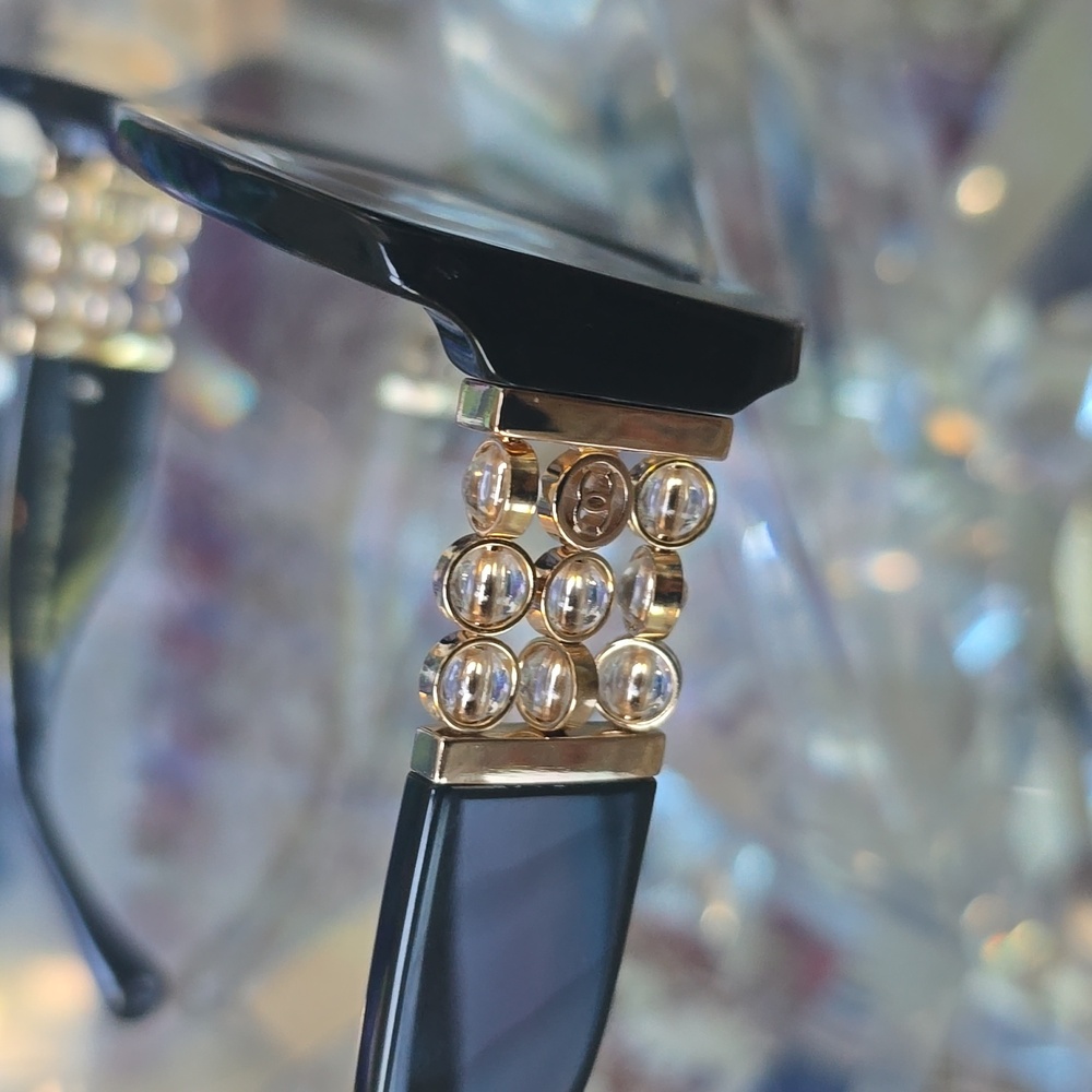 Elegant Black CHANEL Sunglasses with Gold Accents - Picture 2 of 5
